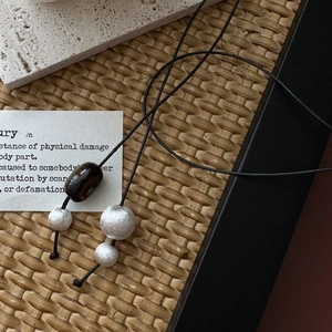 Minimalist S925 silver beaded necklace with brushed metallic spheres on a black cord