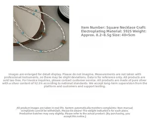 Detail of S925 silver necklace with turquoise beads and brown wooden squares