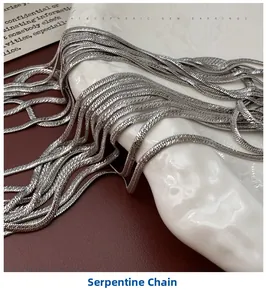 Detail of silver S925 herringbone chain showing the flat snake bone texture on white plate