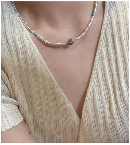 Close-up of S925 silver beads and turquoise stones on a boho-style necklace