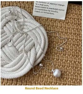 Detail of S925 sterling silver frosted ball pendant on a woven rattan texture surface
