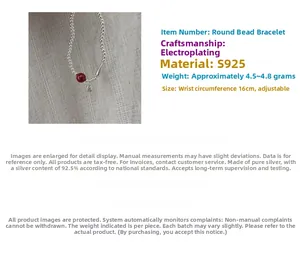 Detailed close-up of S925 sterling silver beaded bracelet with red cinnabar charm