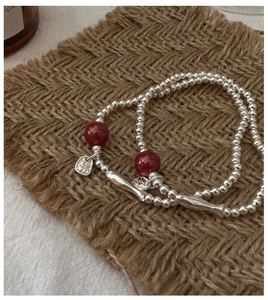 Close-up of S925 sterling silver beaded bracelet with Fu character pendant and red beads