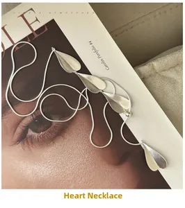 Artistic layout of S925 sterling silver heart necklace on lifestyle magazine background