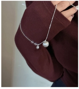 Detail of silver dual bead necklace with mirror polish and brushed texture contrast