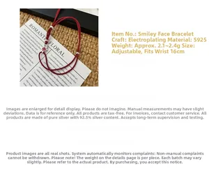Detail view of S925 silver smiley face charm on red cord bracelet with adjustable chain