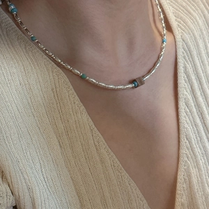 S925 silver beaded necklace with turquoise and metal beads on a knitted sweater