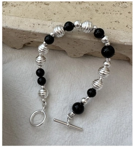 Detailed close-up of S925 silver and black onyx beaded bracelet with toggle clasp