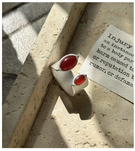 Detailed macro view of S925 sterling silver open ring with dual red agate stones