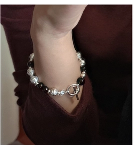 Detailed close-up of S925 silver beaded bracelet with black onyx and elegant T-bar clasp