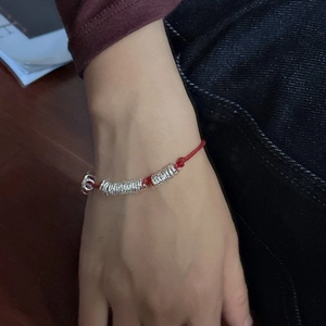 Minimalist red cord bracelet with multiple S925 silver rings worn on a female wrist