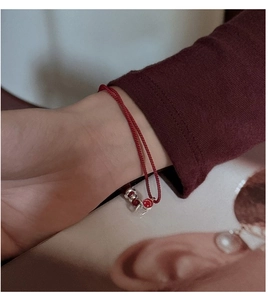 Close-up of S925 sterling silver red smile bracelet worn on a female wrist