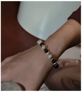 Detail view of S925 silver beaded bracelet with dark onyx on a lifestyle background