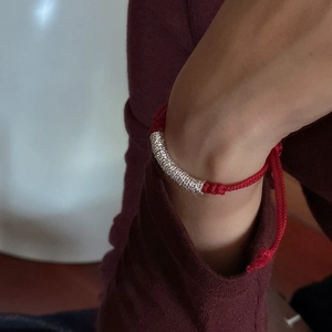 S925 Sterling Silver red rope bracelet with spiral metal tube on a woman's wrist