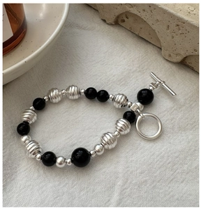 Detail of S925 silver beaded bracelet with black agate beads and a stylish toggle clasp