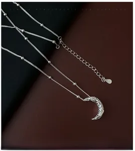 Detail view of S925 sterling silver moon necklace with hammered texture and hallmark