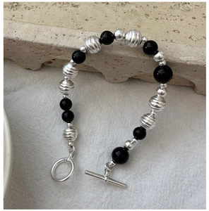Close-up of S925 silver and black onyx beaded bracelet with a textured OT toggle clasp