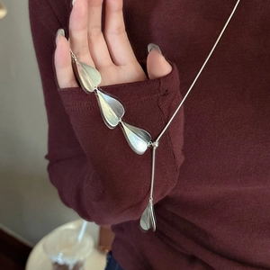 S925 sterling silver long sweater chain with minimalist teardrop pendants on red knitwear