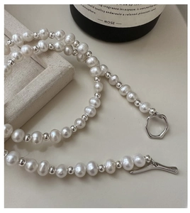 Macro shot of S925 sterling silver toggle clasp and natural pearls on a necklace