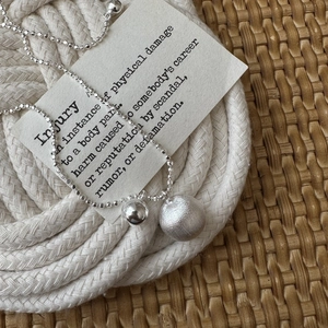 S925 sterling silver frosted ball pendant necklace on elegant minimalist white background