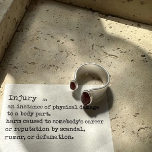 Retro S925 sterling silver matte ring with dual oval red agate stones on stone background