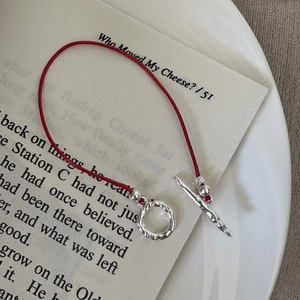 Red cord bracelet with S925 sterling silver hammered texture OT clasp toggle on a white background