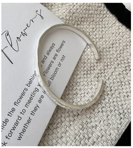 Detail of S925 sterling silver cuff bracelet featuring a matte irregular textured finish