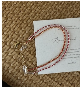 Detail of red braided silk bracelet showing S925 sterling silver clasp and adjustable chain