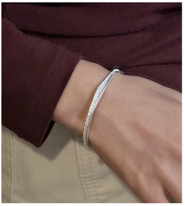 Detail of S925 sterling silver cuff bracelet with vintage irregular hammered texture