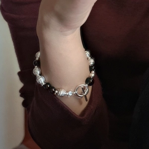 S925 Sterling silver beaded bracelet with black agate and toggle clasp on wrist