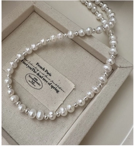 Close-up of S925 sterling silver necklace with white pearls and OT toggle clasp detail