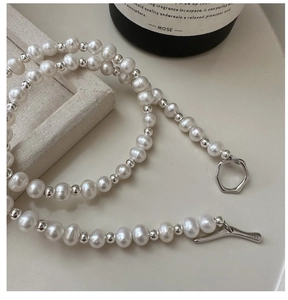 Detail of S925 sterling silver OT clasp with engraved hallmark and freshwater pearls
