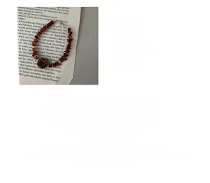 Detail of S925 silver bracelet featuring reddish-brown stones and flower pendant charms