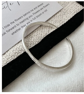 Detailed close-up of matte S925 sterling silver cuff with handmade hammered texture