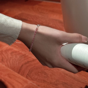 Minimalist 925 sterling silver red woven bracelet for women in a warm aesthetic setting