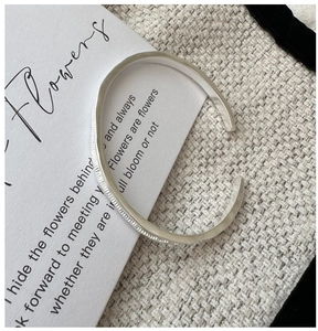 Detailed view of S925 sterling silver cuff with frosted hammer texture on fabric base