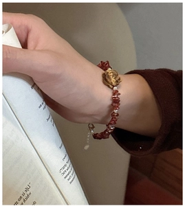 Detail shot of a s925 silver vintage rose bracelet with reddish-brown crystal beads