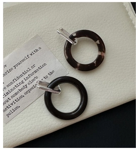 Detailed macro view of S925 silver earring buckle with textured dark marble resin ring