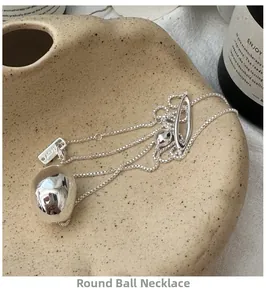 Macro view of S925 sterling silver lava bean pendant on a delicate box chain necklace
