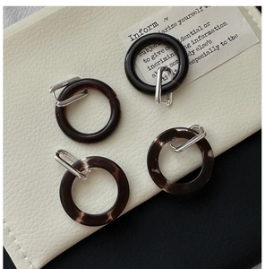 Detailed macro view of S925 sterling silver earrings with dark brown resin texture