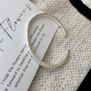 Minimalist S925 sterling silver open bangle featuring a matte textured brushed finish