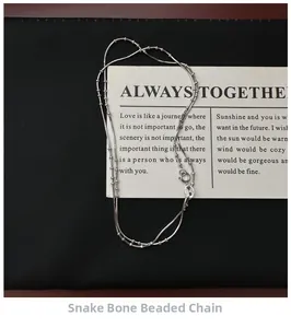 Detail of S925 sterling silver snake bone bead chain necklace on black leather
