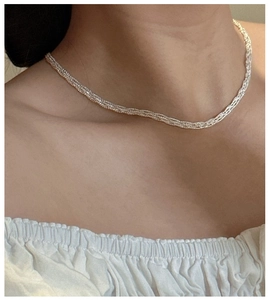 Close-up of S925 sterling silver woven lace necklace on neck for elegant jewelry detail