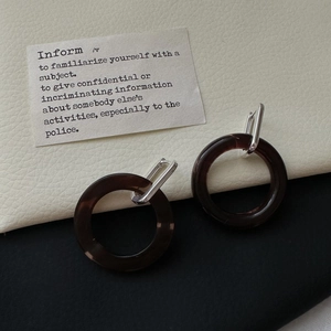 Minimalist S925 silver hoop earrings with dark brown resin rings on a textured background