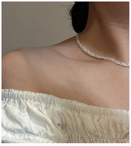 Close-up of sparkling S925 sterling silver woven lace chain on model neck