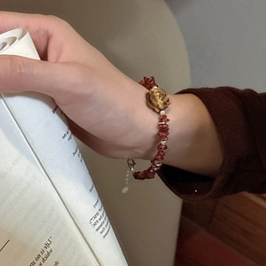 Vintage S925 silver bracelet with red garnet stones and a central golden rose detail