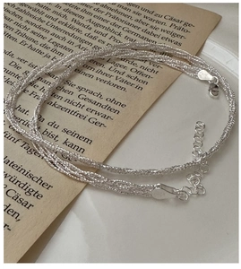 Close-up of S925 sterling silver triple-strand woven necklace with lobster clasp and stamp