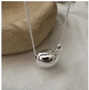 Detailed close-up of polished S925 sterling silver bean pendant with sleek box chain