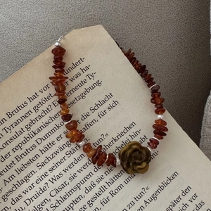 S925 silver beaded bracelet with amber stones and tiger eye rose flower on vintage book