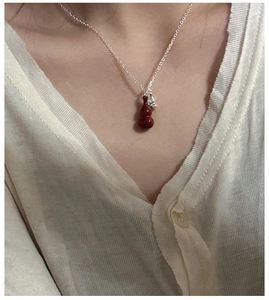 Close-up of S925 silver necklace with red gourd pendant worn on a model neck